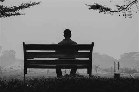 lonely retiree from air traffic control, seated on a park bench looking distant