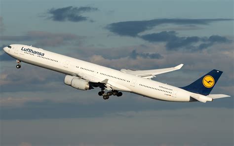 Lufthansa Airbus A340-600 taking off against cloudy skies