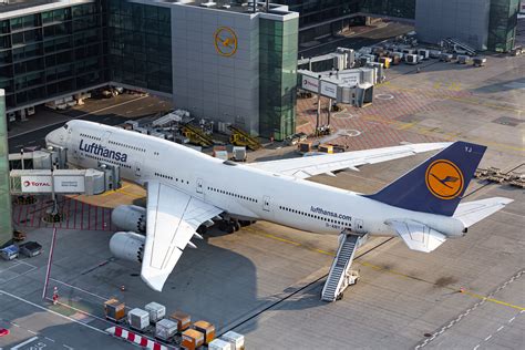 lufthansa boeing 747-400 taxiing at frankfurt airport with terminal in background