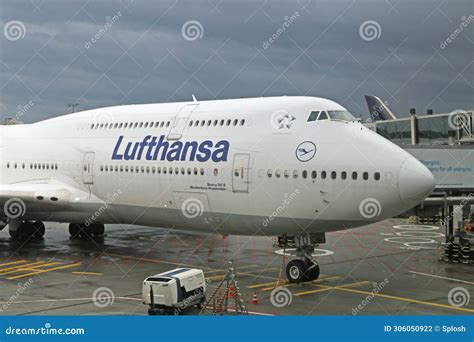 Lufthansa Boeing 747-8i parked at gate with loading bridge attached