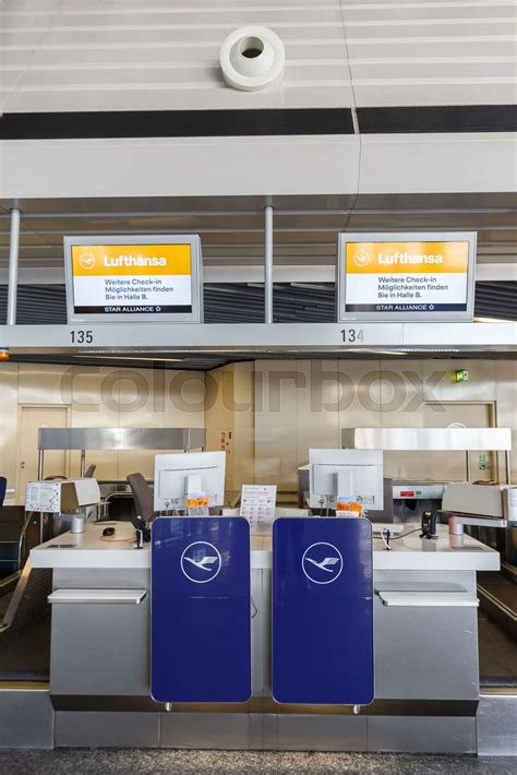 Lufthansa check-in counter displaying Economy Basic baggage fee information