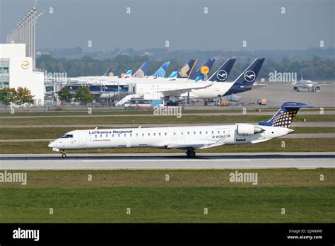 Lufthansa CityLine regional jet parked at Munich Airport gate