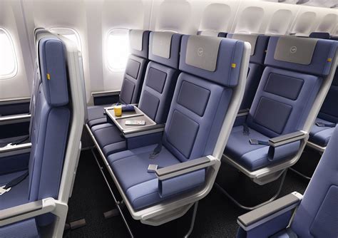 Lufthansa economy cabin passengers texting smartphones