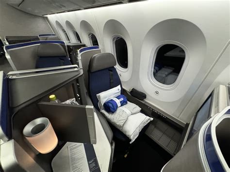 Luxurious United Polaris business class seat with bedding and amenities SFO-SYD flight