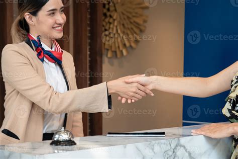 luxury hotel guest shaking hands with concierge at check-out