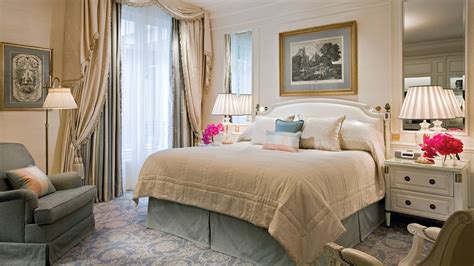luxury hotel suite bed with decorative pillows prepared by housekeeping