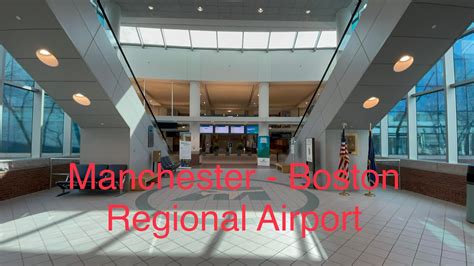 Manchester Boston Regional Airport departure hall with passengers and signage