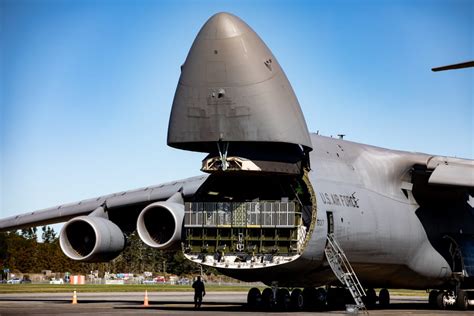 massive Lockheed C-5 Galaxy military transport aircraft on runway with towering tail