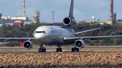 McDonnell Douglas MD-11 on final approach under sunset skies