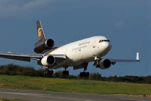 McDonnell Douglas MD-11 touching down with main landing gear compressing on runway
