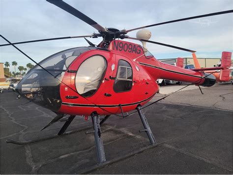 MD 520N helicopter in flight over urban landscape