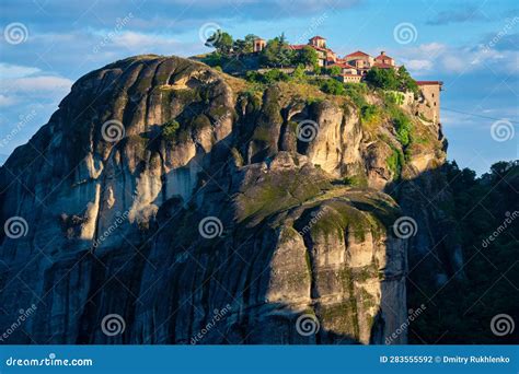Meteora monasteries perched atop towering sandstone pillars at dawn