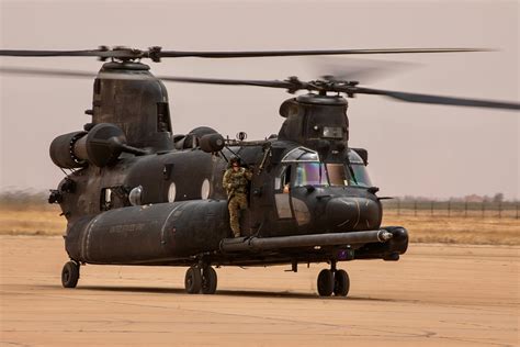 MH-47G Chinook being refueled midair by MC-130 during night training mission