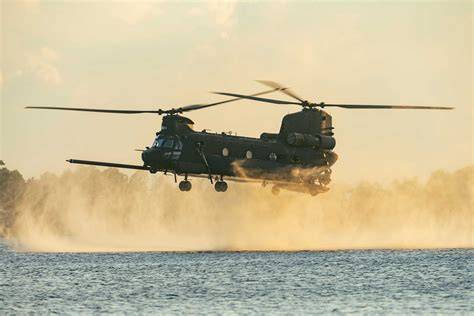 MH-47G Chinook helicopter touching down on autonomous barge for at-sea refueling and resupply test