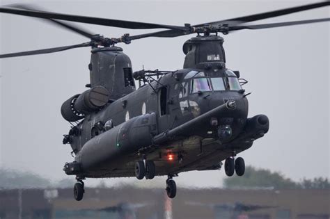 MH-47G crew conducting fast rope insertion exercise at night with NVG