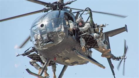 MH-6 Little Bird hovering above rooftop during special ops night drill