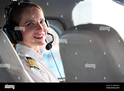 michigan helicopter pilot smiling with headset inside cockpit