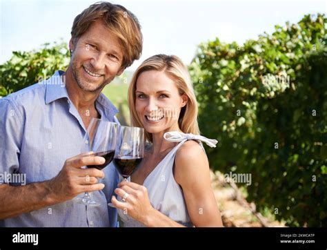 middle-aged couple enjoying wine and conversation in premium economy seating area