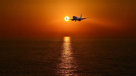 Milan skyline with aircraft flying into sunset