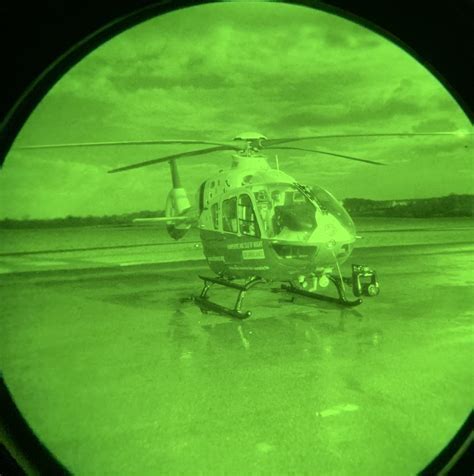 military helicopter crew using night vision goggles during tactical flight