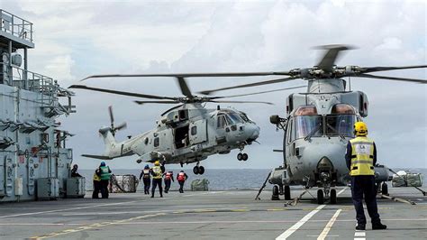 military leonardo aw101 helicopter on naval deck during mission deployment