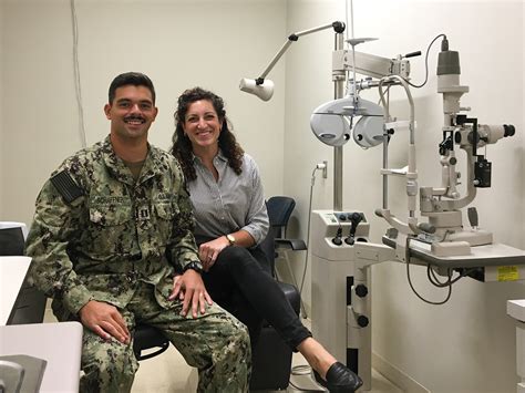 military optometrist conducting a vision screening for a service member