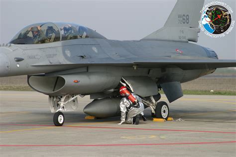 military personnel decontaminating f-16 epu