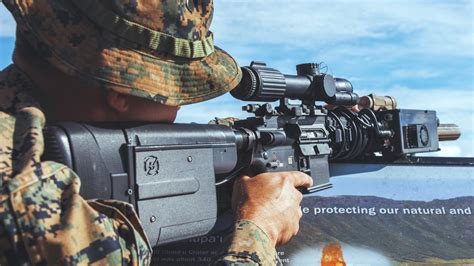 military rifle operator aiming at surveillance drone in combat zone