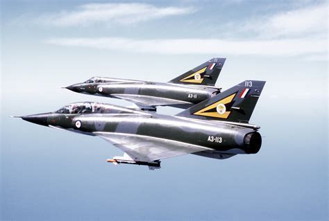 mirage III fighter climbing into blue sky with afterburner