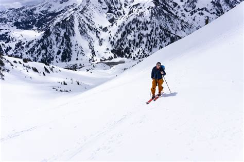 mixed group of heli and touring skiers sharing a bowl in little cottonwood canyon