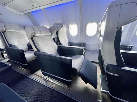 modern airline widebody aircraft premium cabin interior with economy seats behind