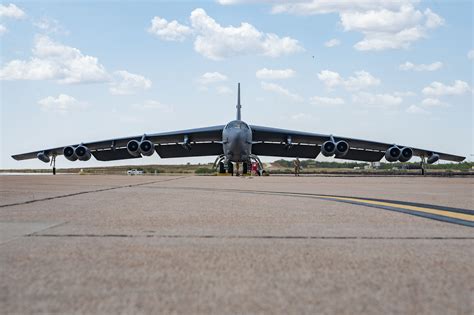 modern B-52 Stratofortress flying toward sunset symbolizing century-long aviation legacy