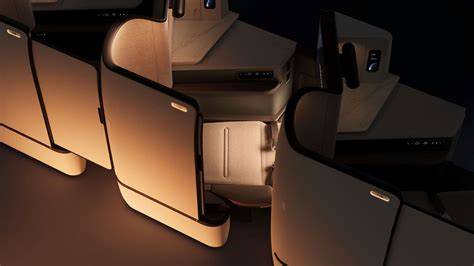 modern business class suite with sliding privacy door, large screen, seat controls, and personal lamp