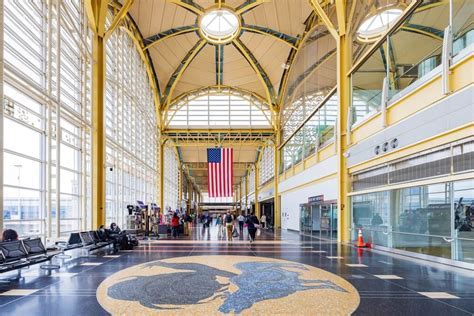 modern interior of DCA Terminal 2 with passengers and skylight roof