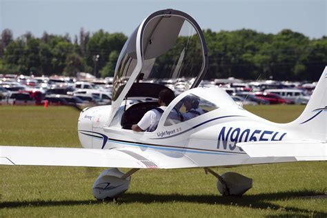 modern light sport aircraft parked at rural airfield in spring