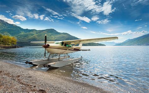 modern seaplane on water with mountains in background