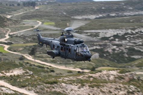 Moroccan H225M helicopter crew in mission-ready stance with advanced gear