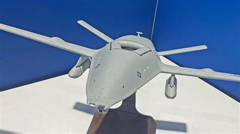 MQ-25 Stingray on carrier deck with fuel hose extended