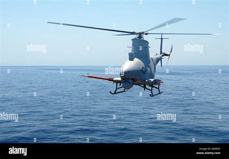 MQ-8 Fire Scout landing on US Navy LCS in open ocean under sunset light