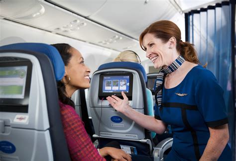 multilingual flight attendant interacting with passengers on international flight