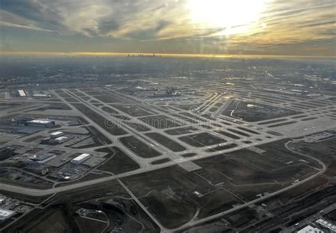 multiple commercial jets taking off from Chicago O’Hare runways at sunset