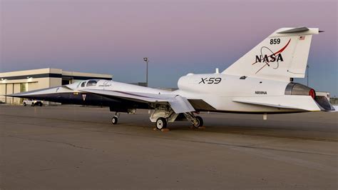 NASA X-59 QueSST supersonic experimental aircraft parked at hangar, representing next-gen designs