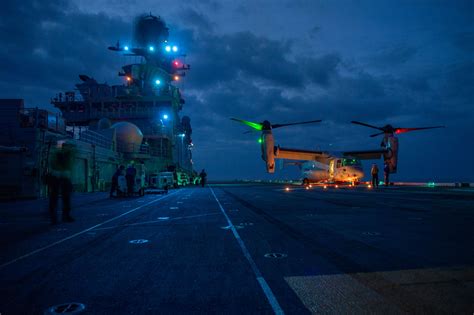 naval pilot conducting manual carrier landing during night operation