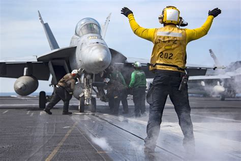 Navy carrier pilot preparing for catapult launch aboard aircraft carrier