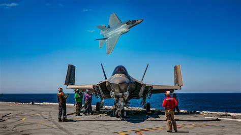 Navy F-35 fighter jet launching from electromagnetic carrier catapult