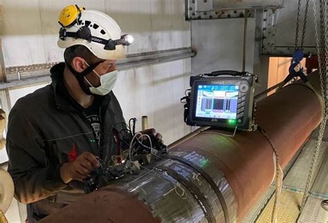 ndt inspector reviewing weld X-ray results on digital screen in aerospace quality lab