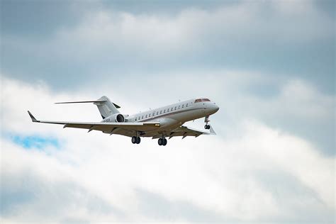 NetJets Bombardier Global 6500 climbing after departure from Westchester County Airport
