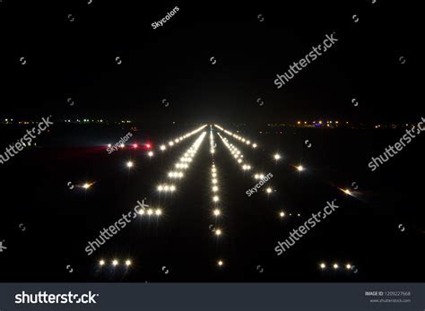 night view of airport runway with papi lights
