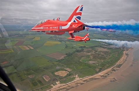 Nine Red Arrows jets in diamond formation emitting white vapour trails using HVO biofuel