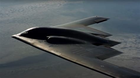northrop b-2 spirit stealth bomber in flight over desert terrain